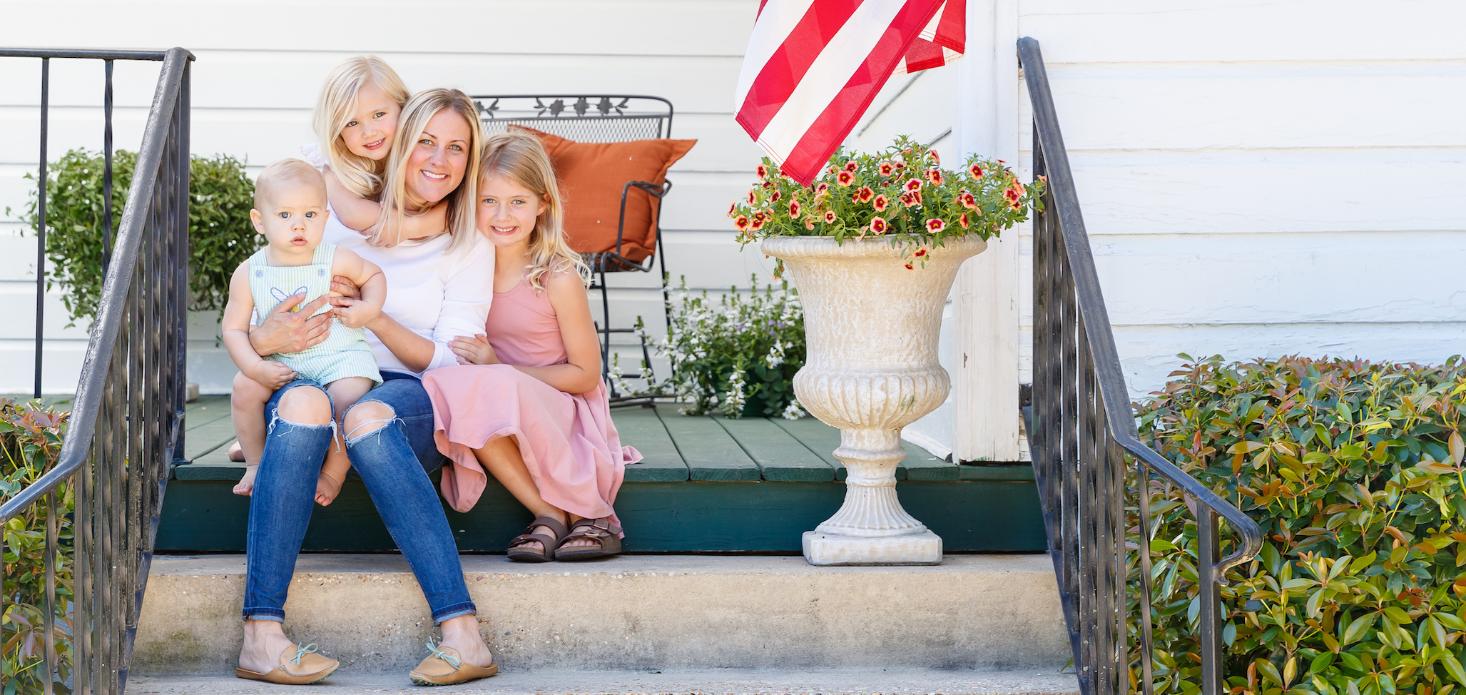 Family on front porch of home