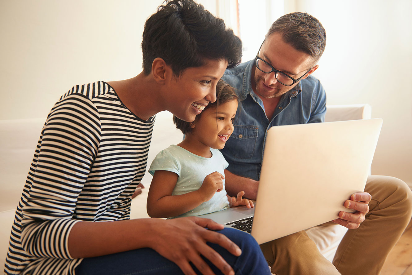 Family looking at a laptop
