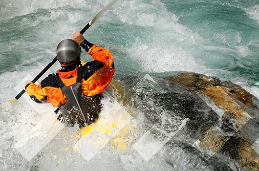 Home Equity Line of Credit - Adventurer kayaking river rapids.