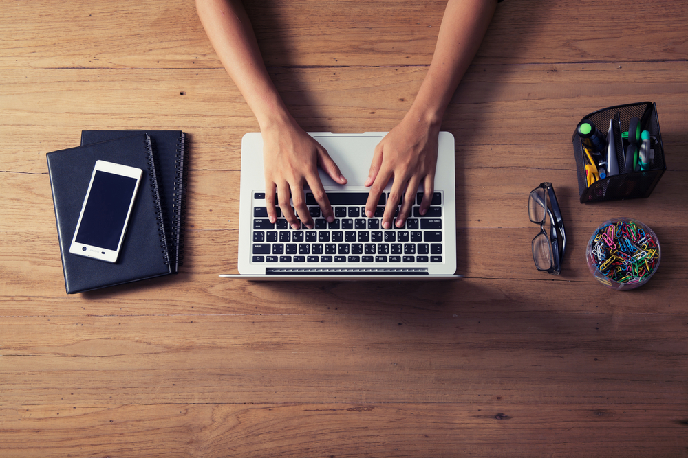 person typing on laptop computer