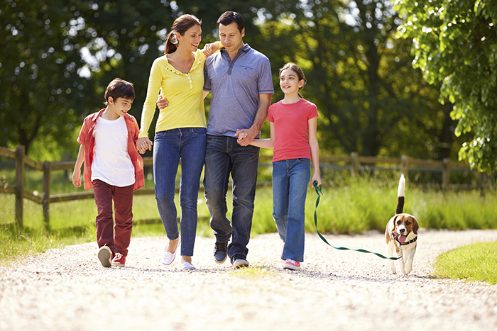 Family of four walking with a dog - types of home loans