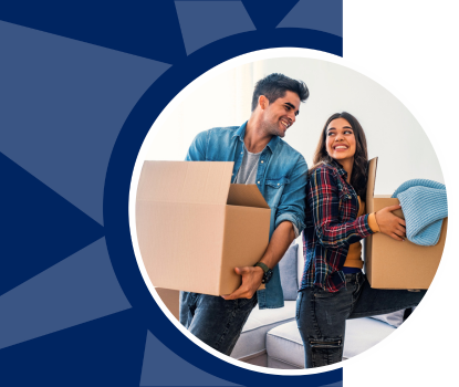 An excited young couple moves boxes into their new home.