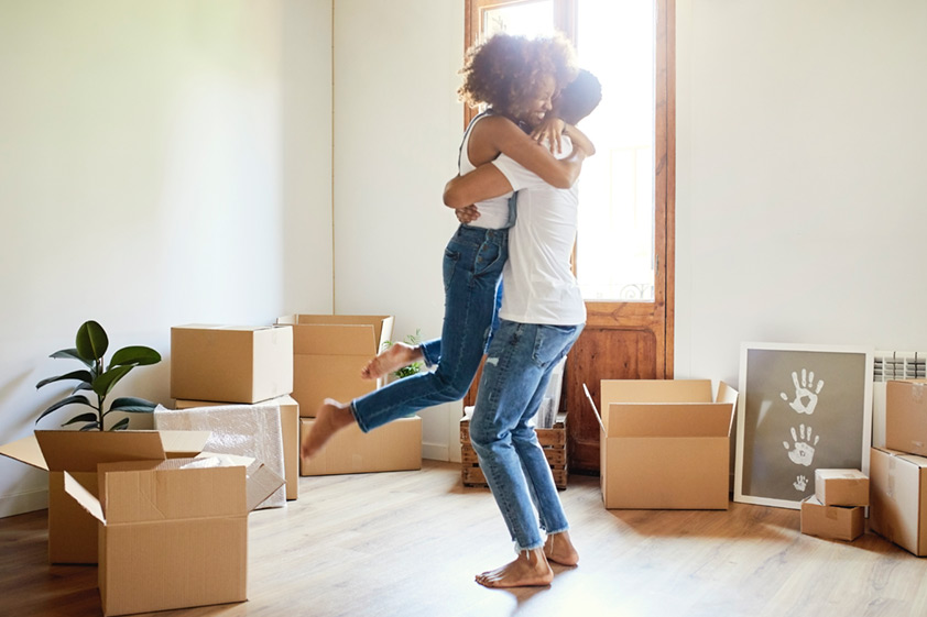 Happy couple hugging in a new home