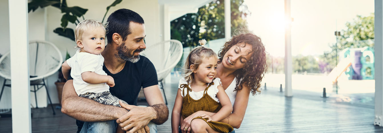 Couple with two small children on front porch