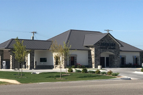 Photo of single story commercial building with bank sign in front
