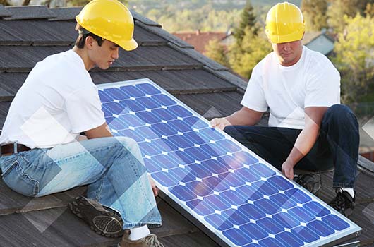 Professionals installing solar panels on a home.