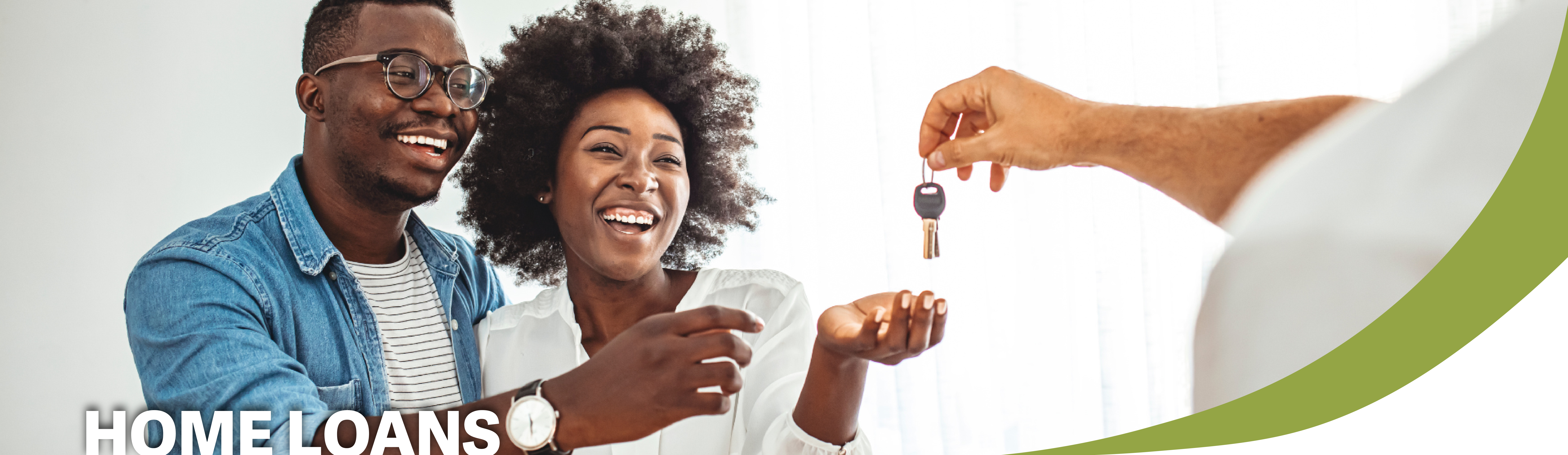 A smiling couple accepts the keys to their new home.