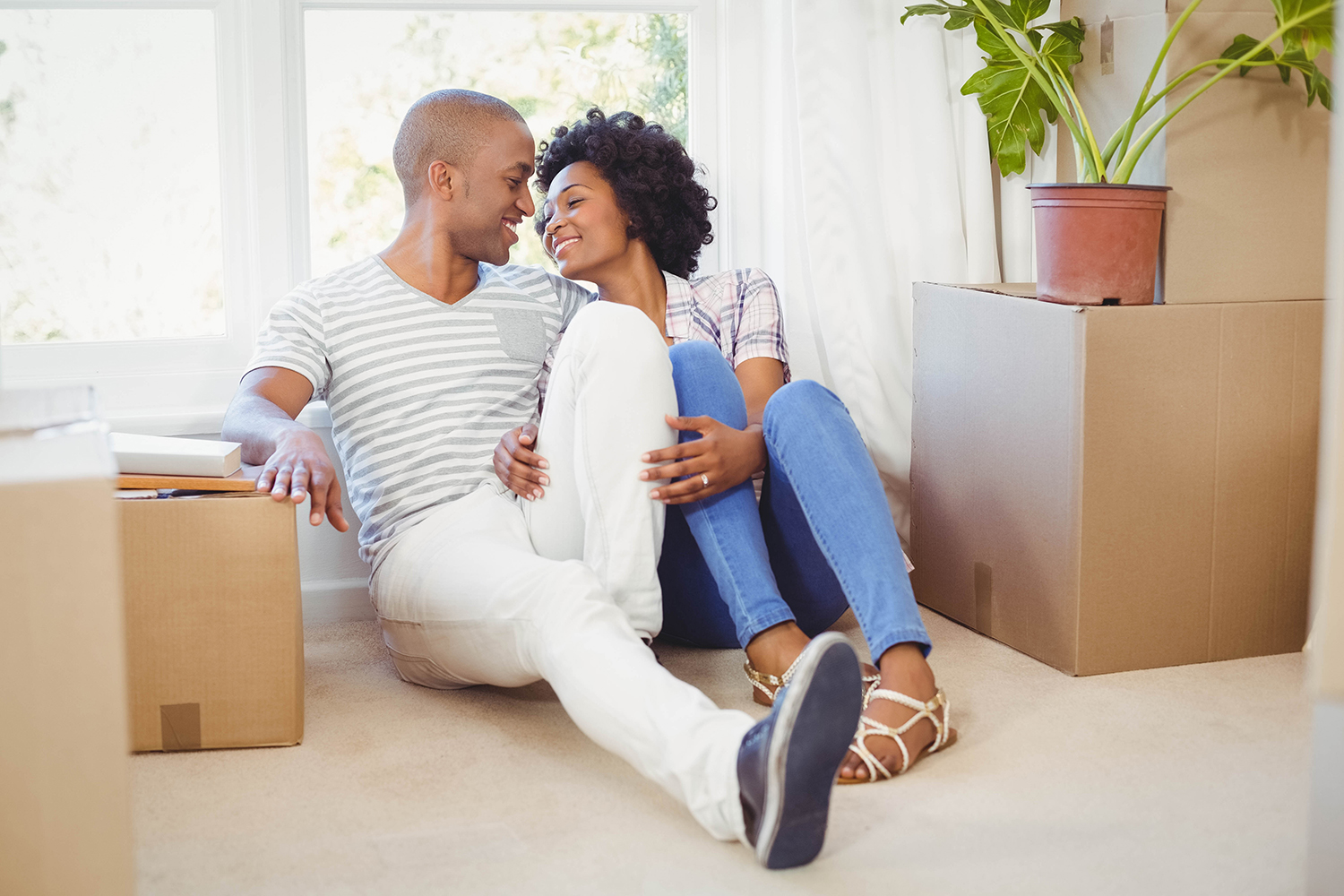 young couple moving into their home - home purchase basics